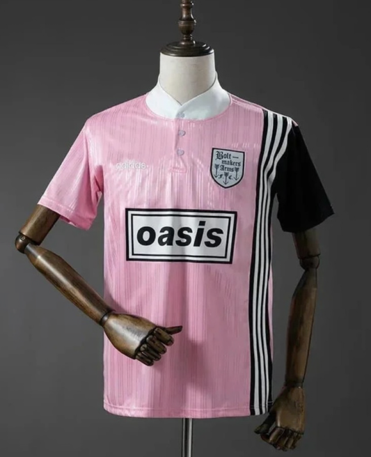 Pink and black Adidas Oasis Tour short sleeve soccer jersey with "Bolt Makers Arms" edition, featuring team logos and design details.