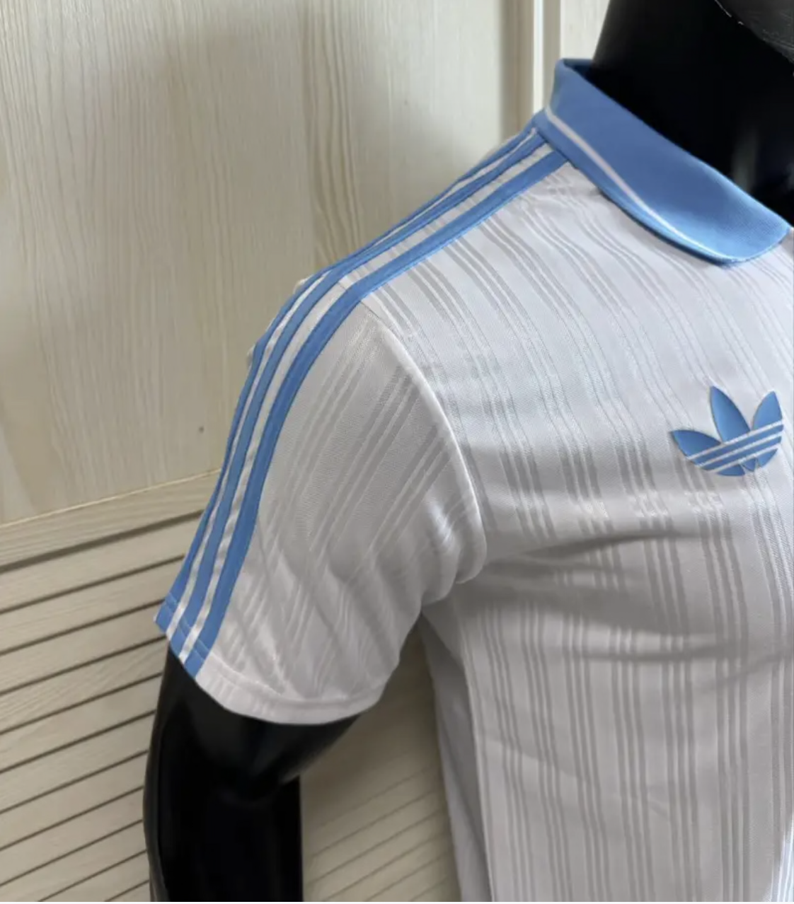 Adidas Oasis Tour "Bolt Makers Arms" edition white and sky blue short sleeve soccer jersey with Adidas logo.