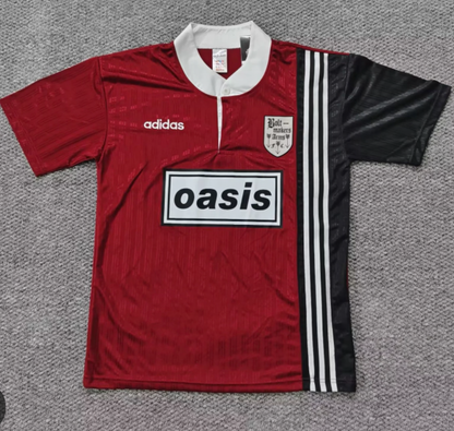 Red and black Adidas Oasis Tour short sleeve soccer jersey with "Bolt Makers Arms" edition, featuring bold design and team branding.