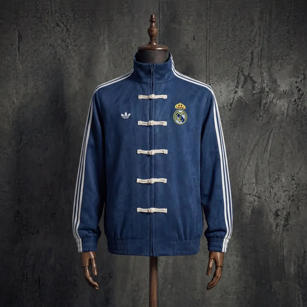 Real Madrid 26/27 OG Lifestyler long sleeve jacket with team crest and design details, in white and blue colors.
