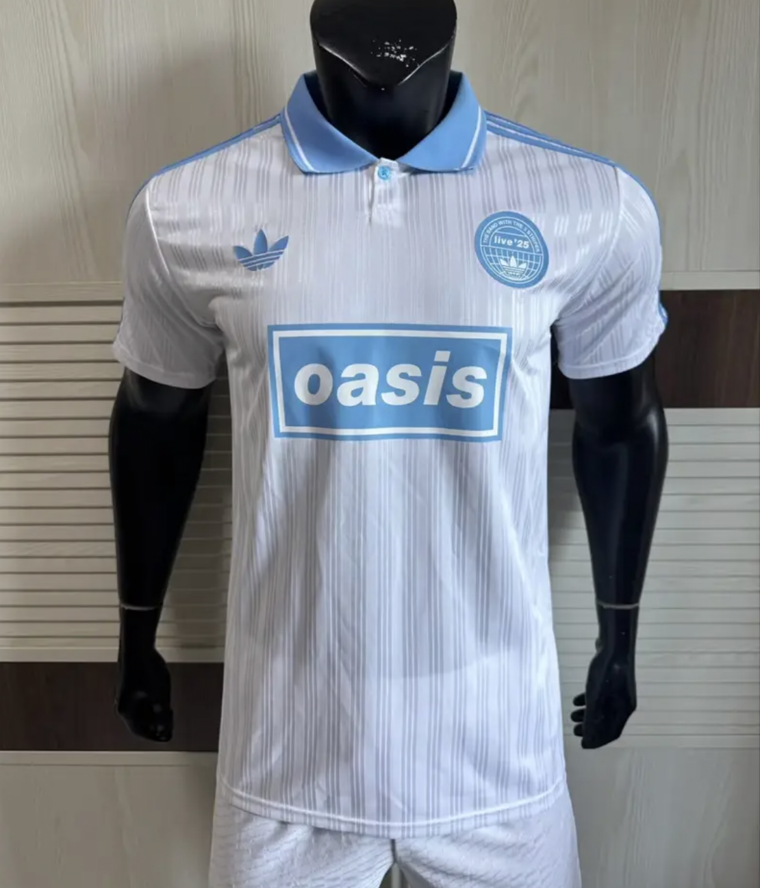Adidas Oasis Tour "Bolt Makers Arms" edition white and sky blue short sleeve soccer jersey with World Cup Retro Soccer Shop branding.