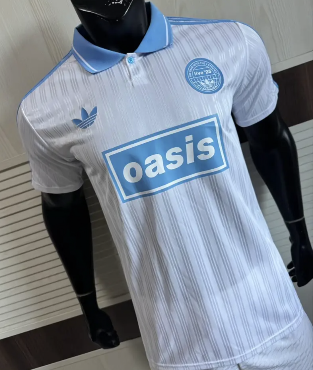 Adidas Oasis Tour “Bolt Makers Arms” edition white and sky blue short sleeve soccer jersey, vintage World Cup retro style.