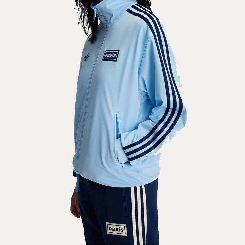 Blue Adidas Original OASIS TOUR long sleeve tracksuit jacket with sporty design, perfect for casual or athletic wear.