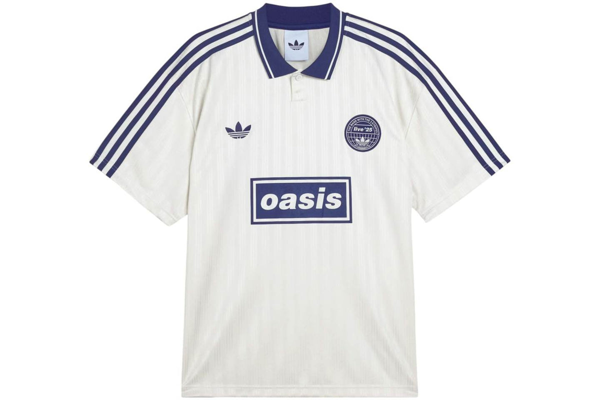 White Adidas OASIS TOUR Lifestyle short sleeve soccer jersey with team logo, displayed on a hanger.