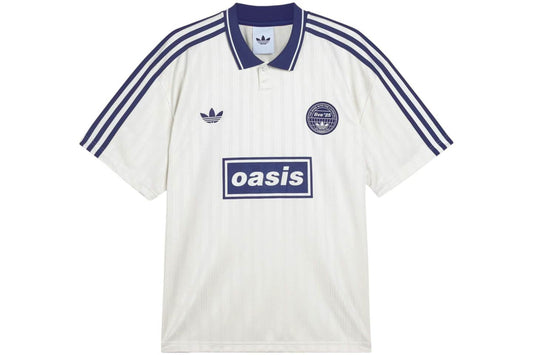 White Adidas OASIS TOUR Lifestyle short sleeve soccer jersey with team logo, displayed on a hanger.